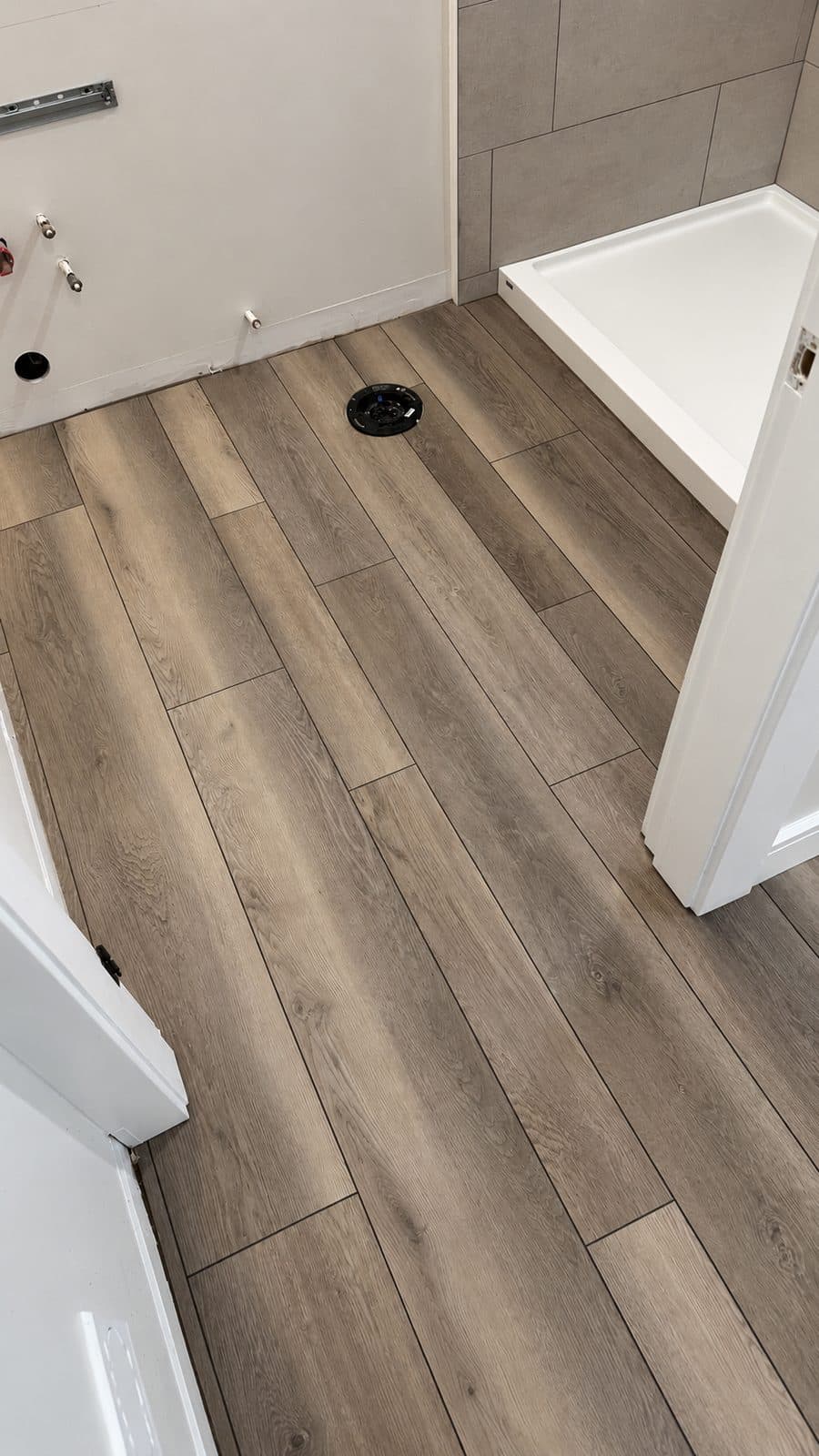 Grey wood-look plank floor in a laundry room