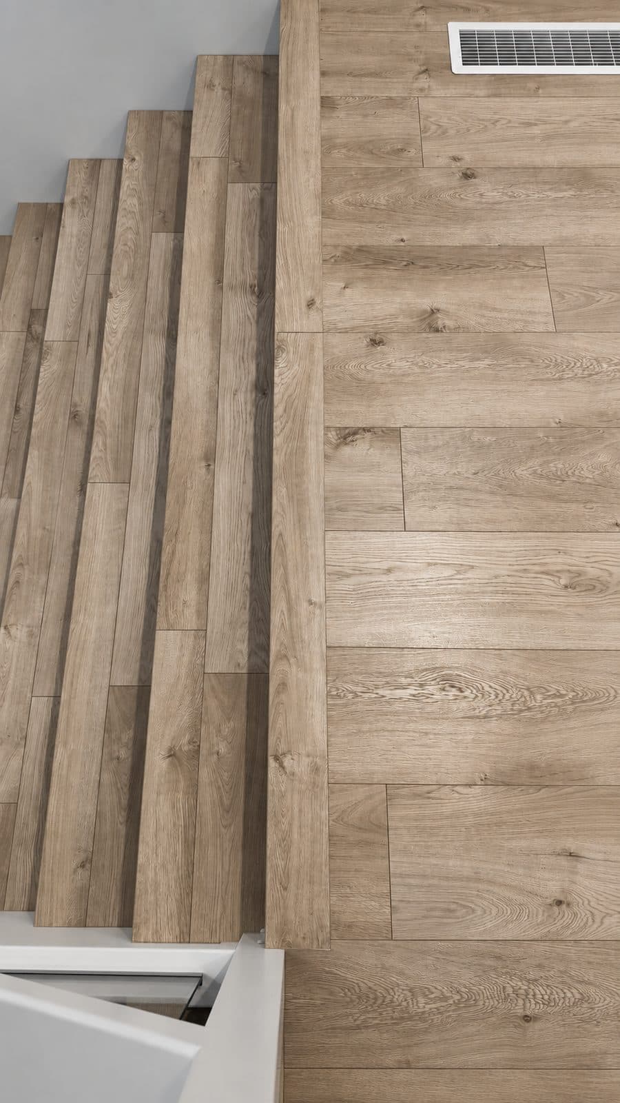Stair treads and floor in matching light wood