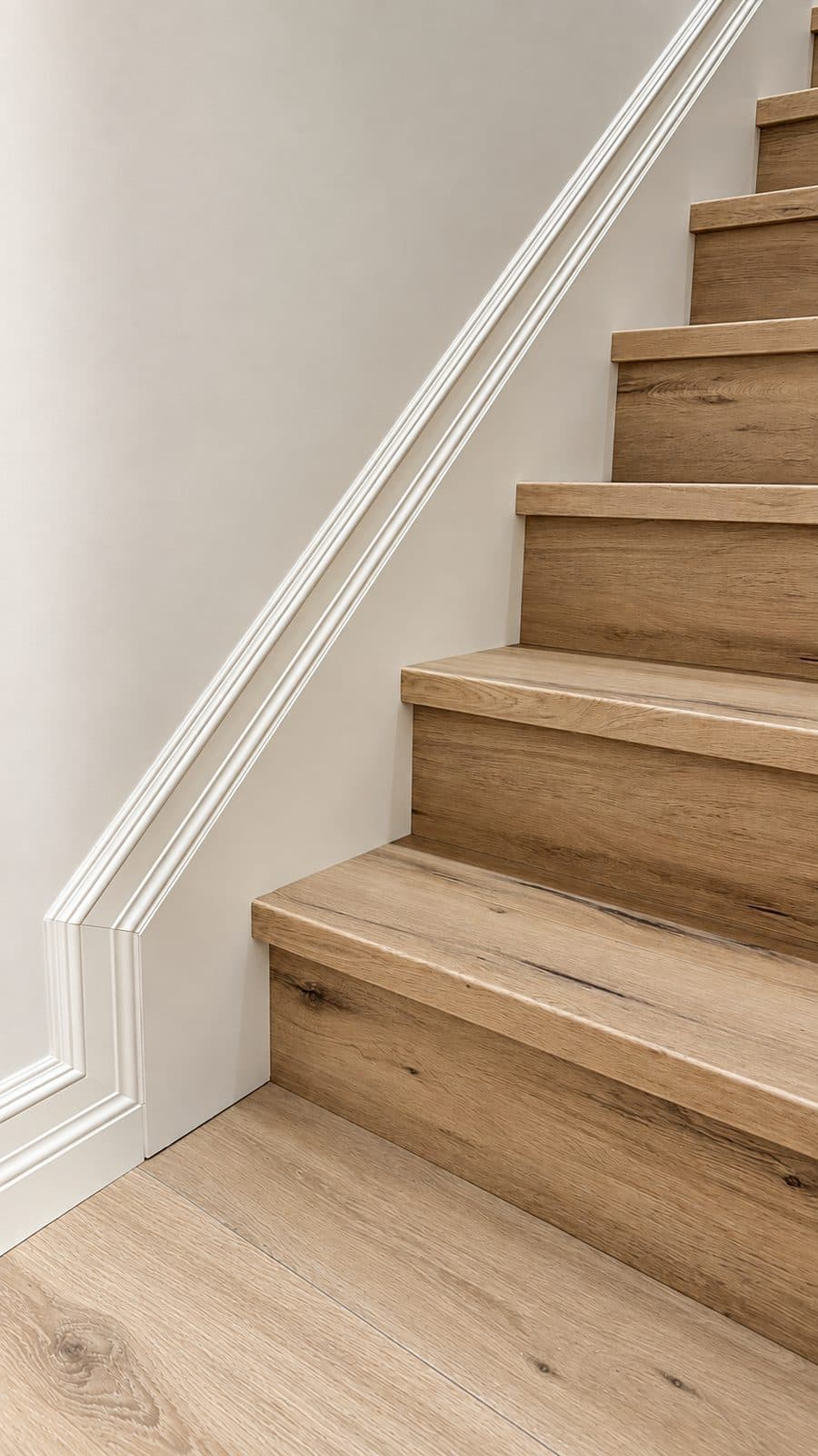 Wood staircase along a white wall