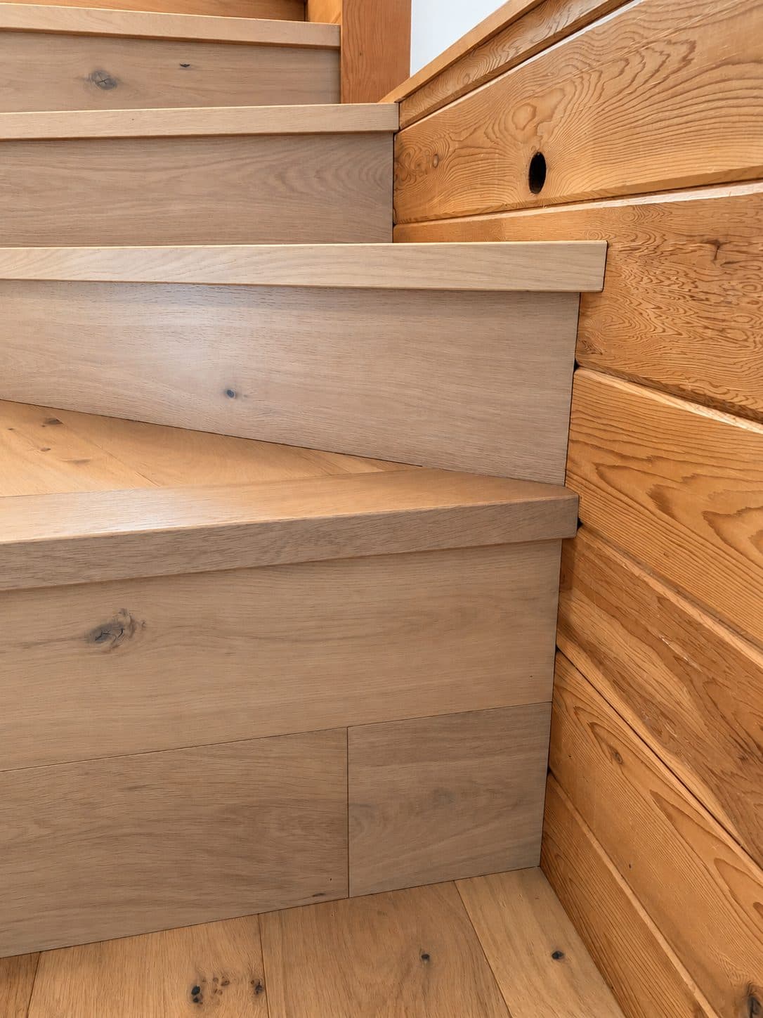 Winding stairs with square nosings against cedar walls