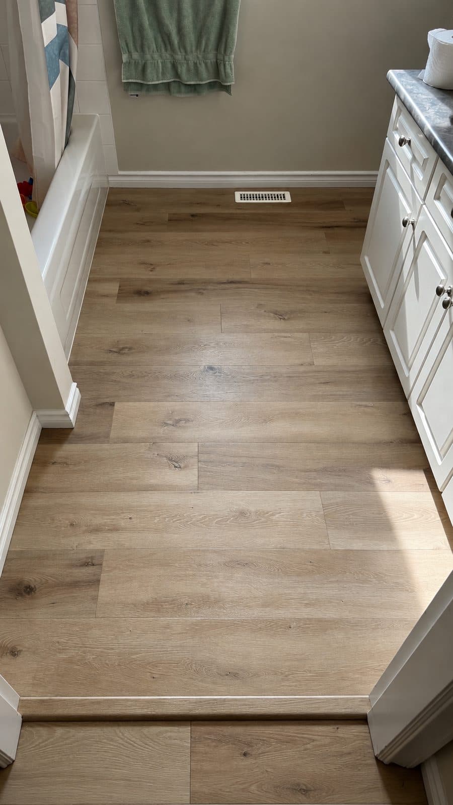 Light wood floor through a galley kitchen