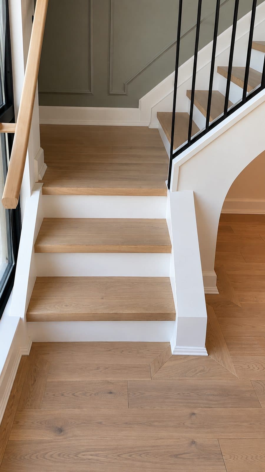 Wood stair treads with white risers and black balusters
