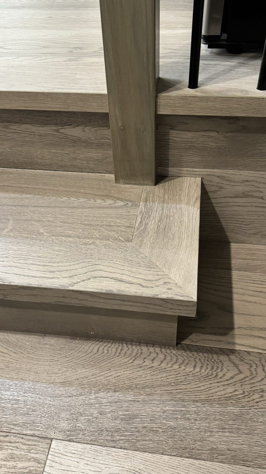 Close-up of a square nosing on a grey wood step